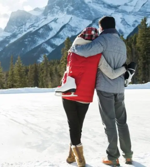 Couple enjoying the snow on their Manali honeymoon