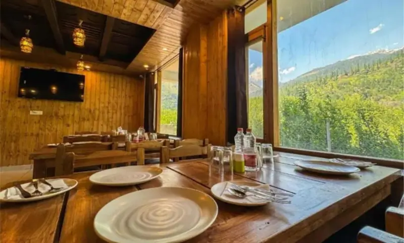 Restaurant dining table with a large window view of the valley